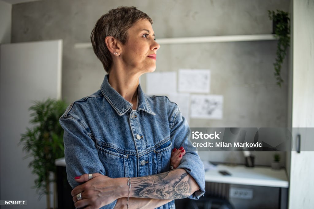 I enjoy my age Portrait of a beautiful mature woman who is in her study room. Menopause Stock Photo