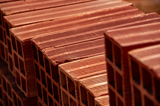 Goiania, Goiás, Brazil – July 08, 2022:  Ceramic bricks arranged in piles and stored outdoors for sale.
