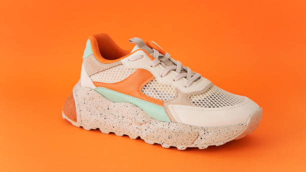 istock Colorful shoes on the orange backround 1407560181