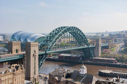 Newcastle upon Tyne UK: 15th April 2022 view of the famous Newcastle Quayside and Tyne Bridge from a high viewpoint (at Above in the Vermont Hotel) on a hazy day