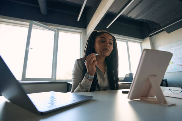 istock Focused corporate employee looking in tabletop mirror during makeup application 1407561757
