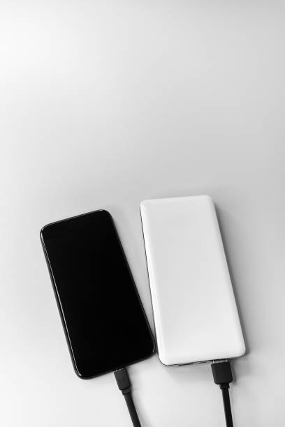 istock Smartphone and power bank during wired charging. 1407569599
