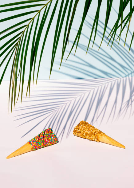 istock Palm tree leaf and colorful ice cream cones on pastel blue background. Summer tropical concept. 1407569728