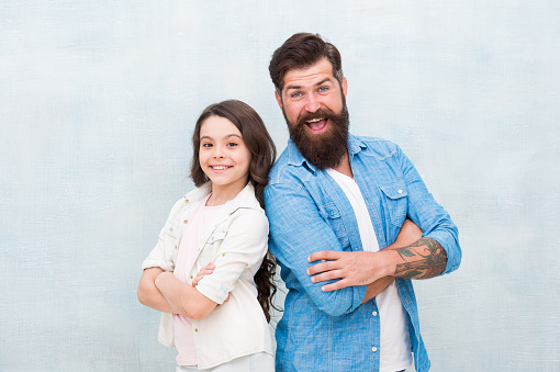 My dad is always there. Happy dad and adorable little daughter smiling on grey background. Bearded dad and small girl child wearing smiling in casual style. My dad is my love.