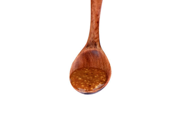 istock Wooden spoon with Bavarian mustard on a white background. 1407575107