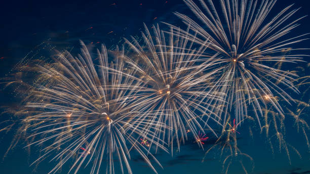 istock Fireworks light up the sky with dazzling display. Abstract colored firework background with free space for text. 1407575333