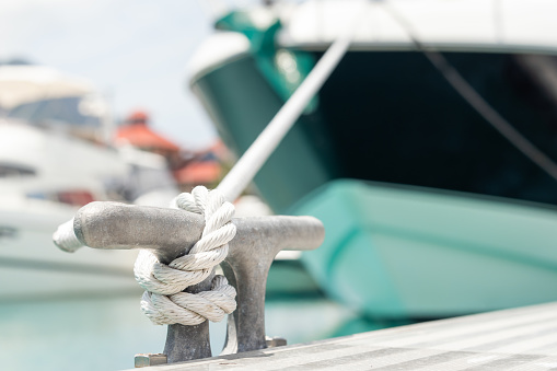 Closeup of the male hands making a bowline nautical knot