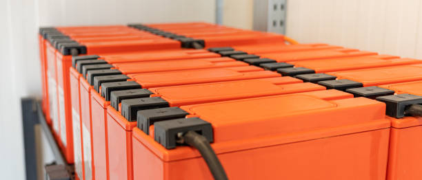 Accumulators on shelves connected to a large UPS battery Accumulators on shelves connected to a large UPS battery. battery storage stock pictures, royalty-free photos & images
