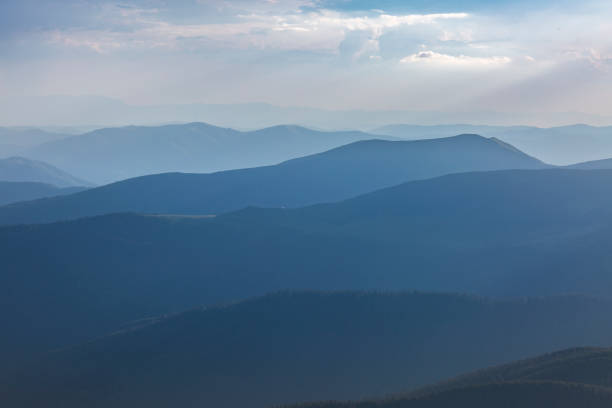 istock Panoranic blue view of mountain hills and meadows during sunset 1407581311