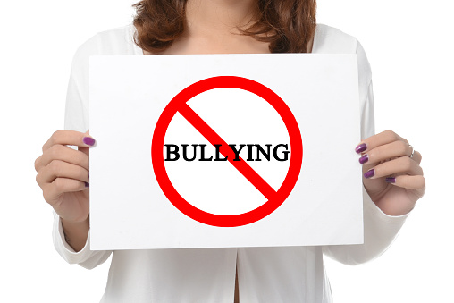 woman showing and holding billboard say no bully  isolated on white background