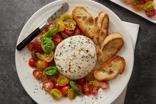 Burrata Antipasto Platter with Grape Tomatoes and Toasted Baguette Slices