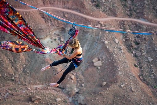 Young woman performing Aerial Silks or Spanish Rope in Moab, Utah