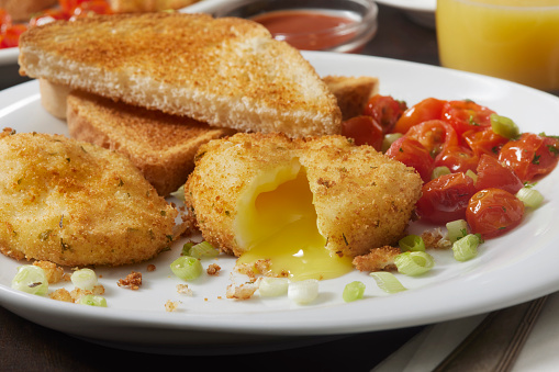 Deep Fried Breaded Poached Eggs with Roasted Tomatoes and Toast