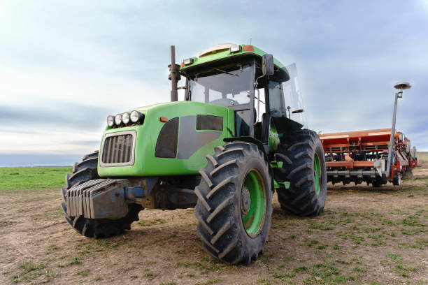 istock tractor with seeder machine parked in a field 1407591302