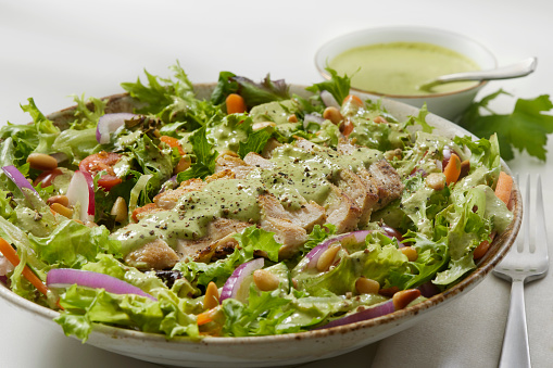 The Viral Green Goddess Salad with Grilled Chicken. Mixed Greens, Radish, Carrots, Tomatoes, Onions, Cucumbers andd Toasted Pine Nuts with a Creamy Cilantro and Avocado Dressing