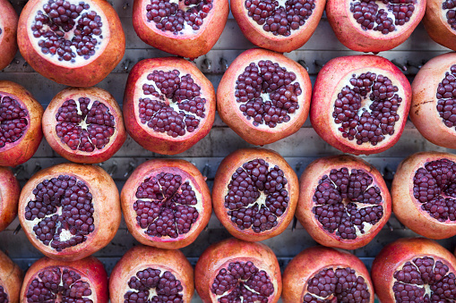 Vibrant red pomegranates on display at Carmel Market, Shuk Hacarmel, in Tel Aviv, Israel