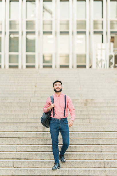 istock Chinese man walking down a stairs in a city 1407602609