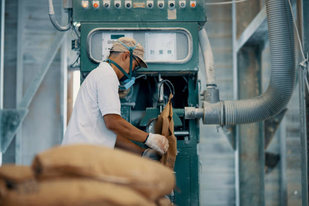 istock Mid adult man working in a factory 1407604921