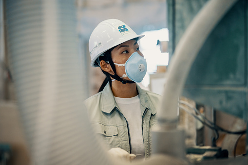 Mid adult woman working in a factory in Japan