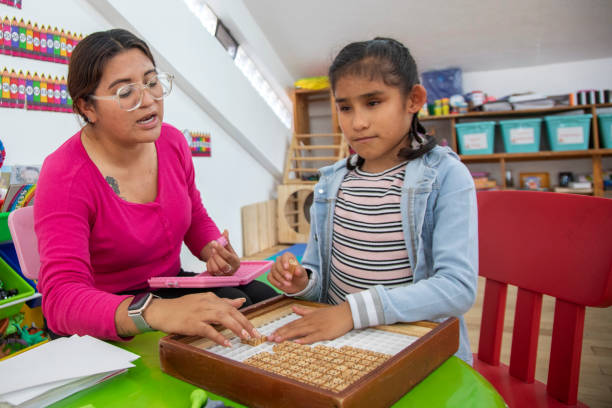 teacher teaching math to blind girl teacher teaching math to blind girl special education stock pictures, royalty-free photos & images