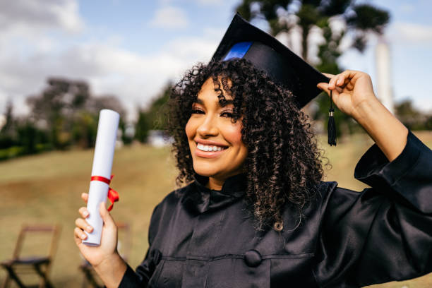 Smiling graduate holding diploma