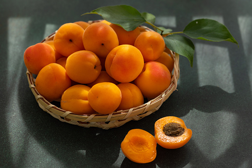 Ripe Delicious Apricots in a Straw Basket