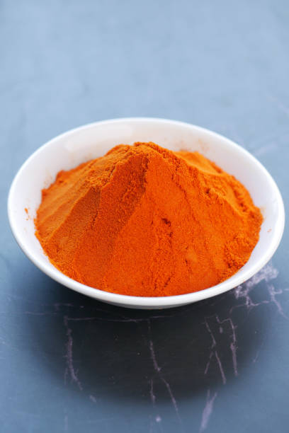 istock Chili powder and red peppers on table background. 1407611577