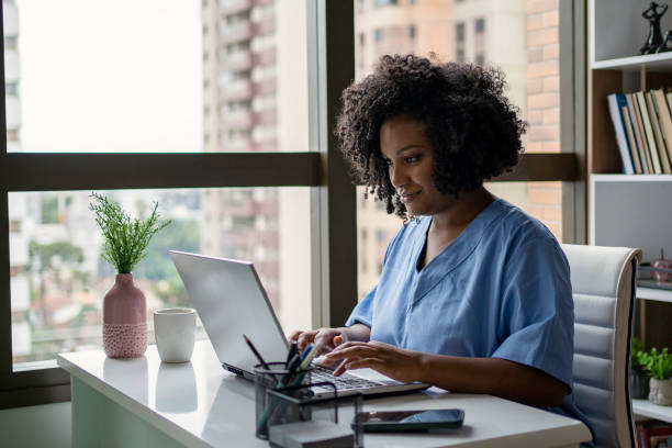 African American nurse working on the desk stock photo