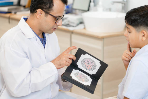 istock Boy doing eye test checking examination with optometrist in optical shop, Indian-thai boy in optics store 1407613535