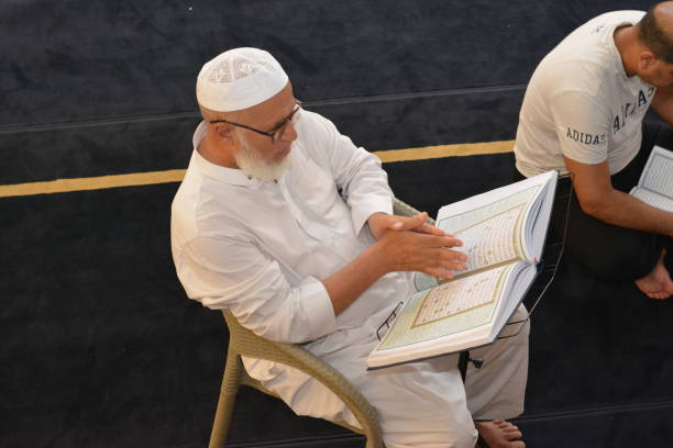 a noble quran reading ring inside a mosque at the day of arafah or arafat before eid al-adha, a group of people reading and learning quran with an islamic imam - cairo mosque koran islam imagens e fotografias de stock