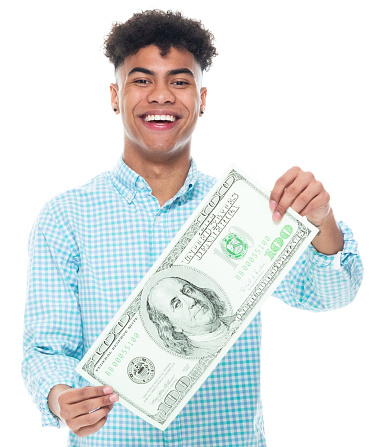 One person of aged 18-19 years old with black hair african-american ethnicity male standing in front of white background wearing rolled-up sleeves who is smiling and holding us currency