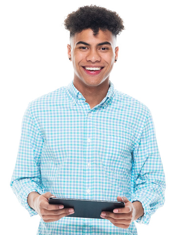 One person of aged 18-19 years old with curly hair african ethnicity young male standing in front of white background wearing shirt who is learning and touching and using touch screen