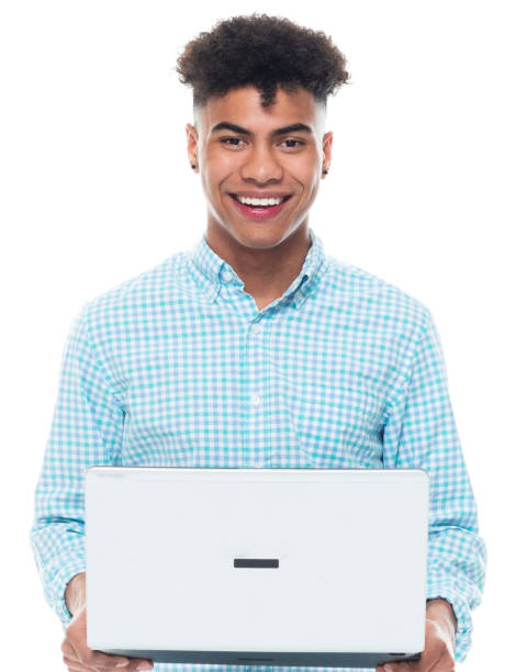 African-american ethnicity male standing in front of white background wearing sports shoe and using computer stock photo