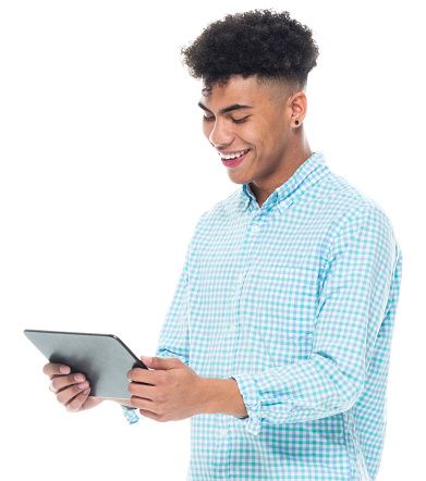 One person of aged 18-19 years old with black hair generation z teenage boys standing in front of white background wearing rolled-up sleeves who is learning and touching and using digital tablet