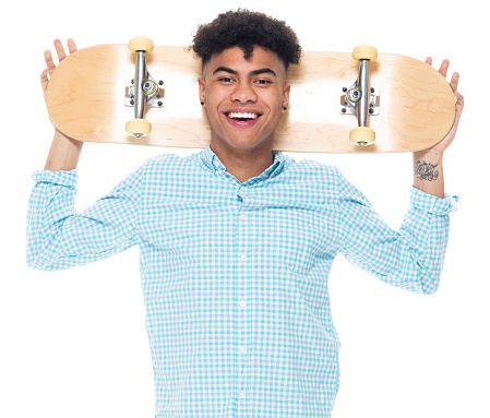 Waist up of aged 18-19 years old with black hair african-american ethnicity boys skateboard in front of white background wearing shirt
