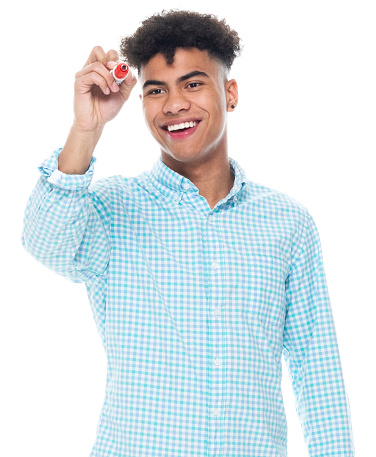 Portrait of aged 18-19 years old with black hair african-american ethnicity boys in front of white background wearing button down shirt who is writing and using pen