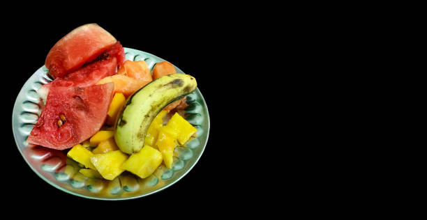istock Plate with different fruits on black background 1407617134