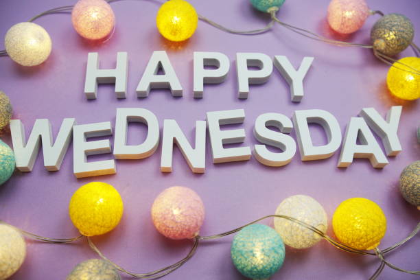 Happy Wednesday alphabet letters with LED cotton balls on purple background Happy Wednesday alphabet letters with LED cotton balls on purple background wednesday morning stock pictures, royalty-free photos & images