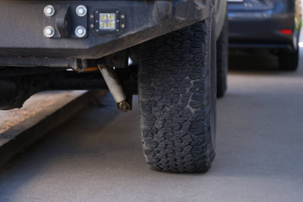 istock Car is incorrectly parked with wheel on pavement closeup 1407620571