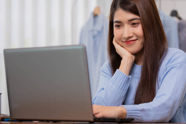 istock Asian working woman is working on her labtop Working from home with relax. 1407622083