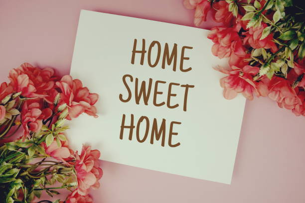 istock Home Sweet Home typography text with flowers on pink background 1407622978