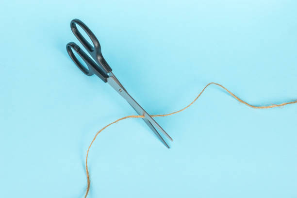 istock Top view of scissors cutting the thread. 1407623998