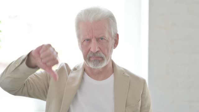 Portrait of Old Man showing Thumbs Down