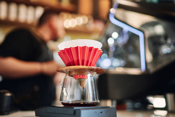 istock Professional barista preparing filter coffee in coffee shop 1407638181