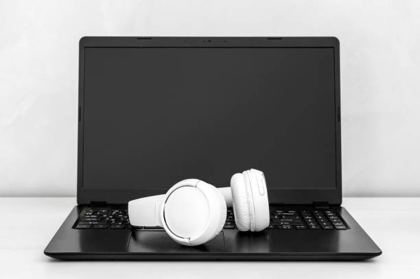 istock Laptop with bluetooth headphones at workplace. 1407638221