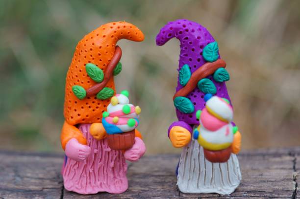 istock Two fabulous dwarfs are holding cupcakes. 1407638684