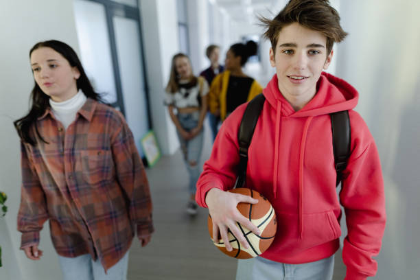 istock Young high school students walking in corridor at school, back to school concept. 1407640980