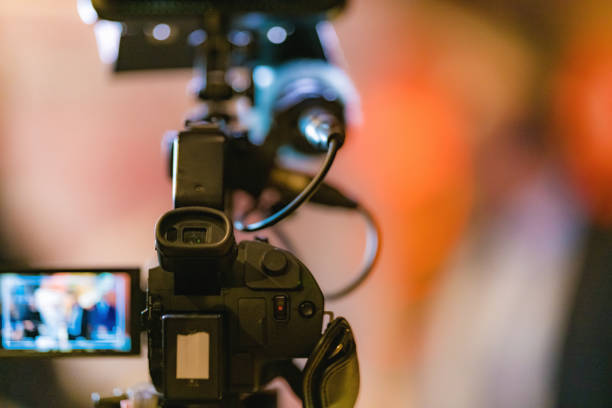 istock Television camera at an evening press conference 1407642474