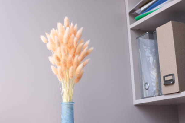 istock Pink flowers hare tails in blue vase closeup 1407642988
