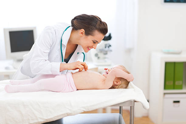 istock Pediatrician doctor playing with baby on examination 140764867